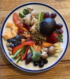 Assortment of whole foods including fruits, vegetables, seeds, nuts, and herbs demonstrating nutrient diversity.