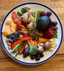Assortment of whole foods including fruits, vegetables, seeds, nuts, and herbs demonstrating nutrient diversity.
